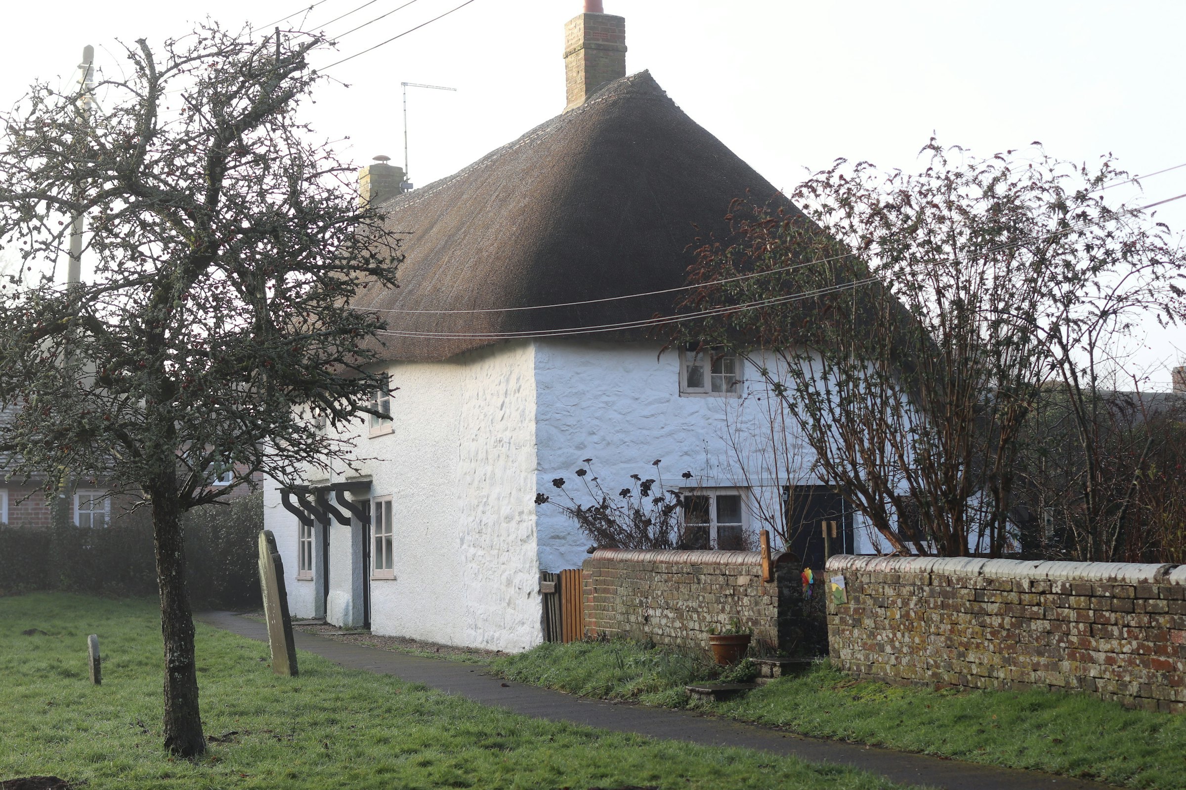 The thatched cottage at the end of the lane in winter